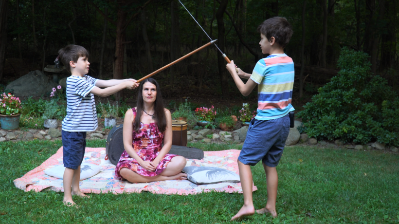 Alexandra Hidalgo watches her sons William and Santiago Hidalgo-Bowler play with her father’s sword in A Family of Stories